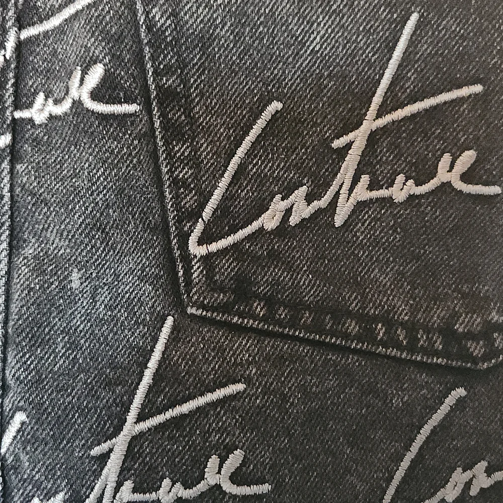 The couture Club Embroidery washed out black Jean Skirt. Size S.